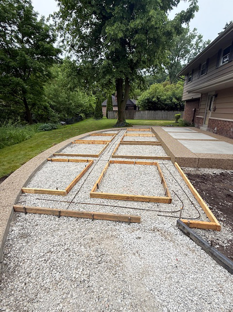 Secondary preparation of exposed aggregate border for decorative concrete patio