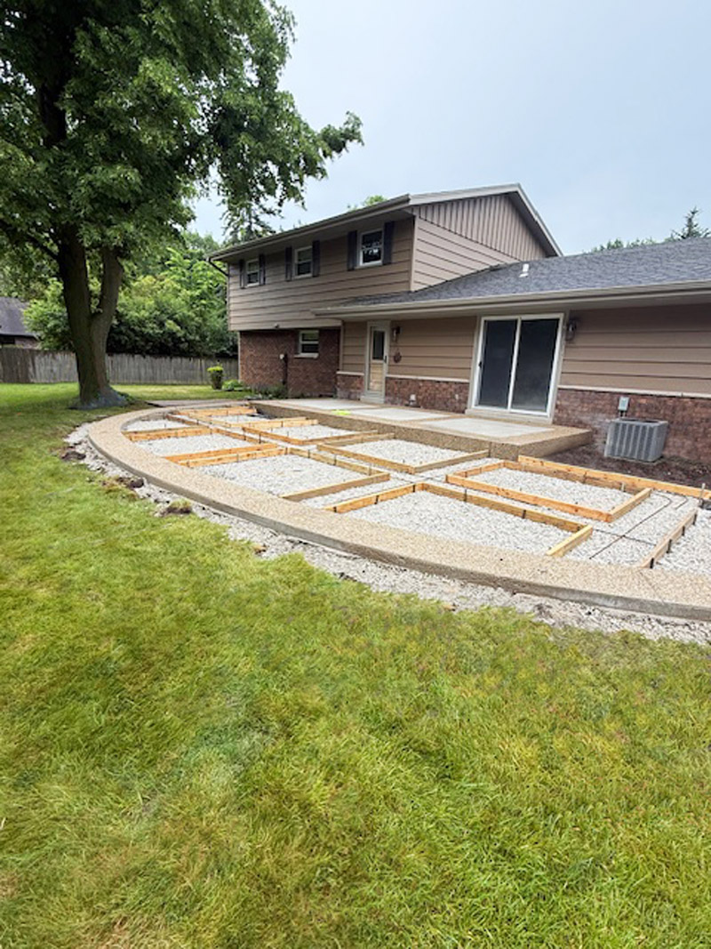 Secondary preparation of exposed aggregate border for decorative concrete patio