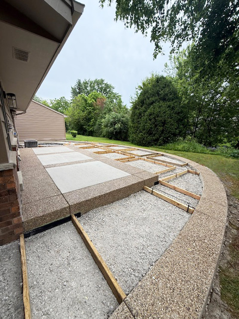 Secondary preparation of exposed aggregate border for decorative concrete patio