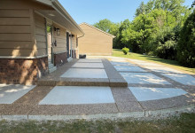 Decorative patio with exposed aggregate border and picture-frame effect using white broomed concrete finish