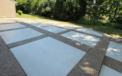 Decorative patio with exposed aggregate border and picture-frame effect using white broomed concrete finish